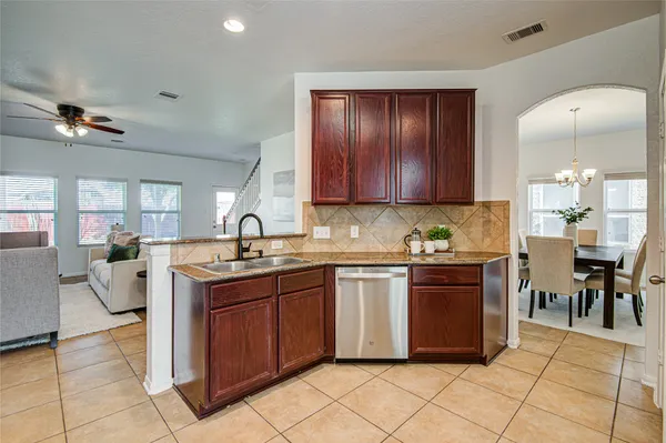 a kitchen with cabinets and chairs