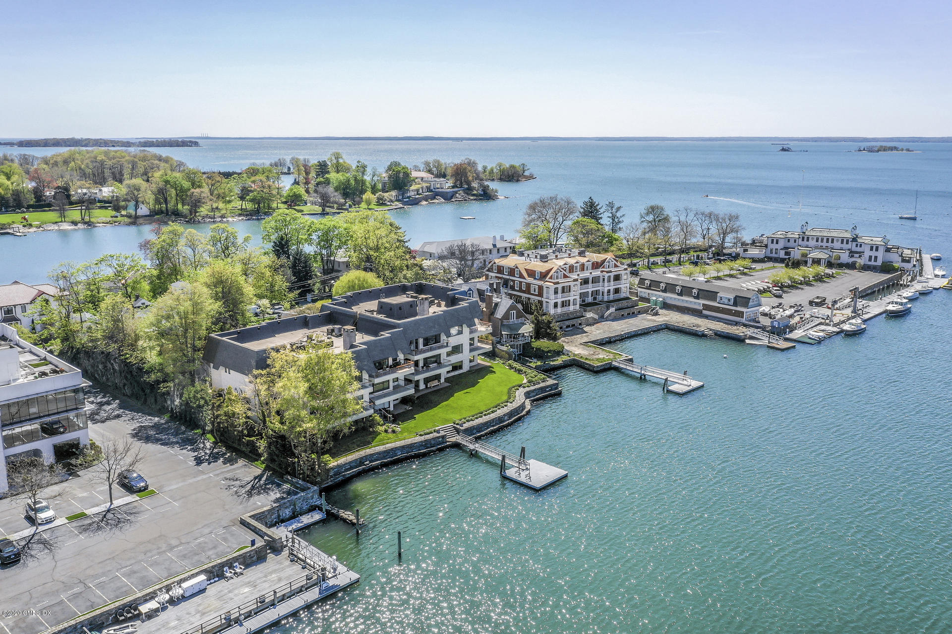 an aerial view of a house with a garden and lake view