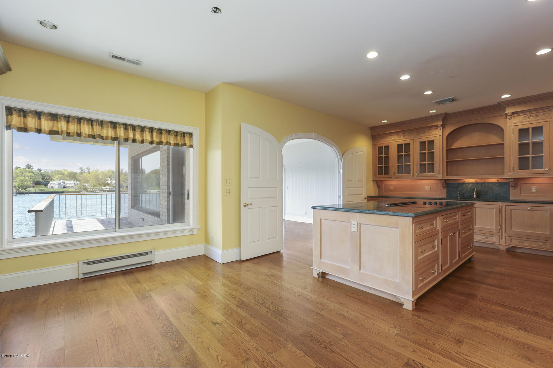 680 Steamboat Road, Unit 6 Greenwich, CT 06830 - Photo 12 of 40 a kitchen with stainless steel appliances granite countertop a stove and a large window