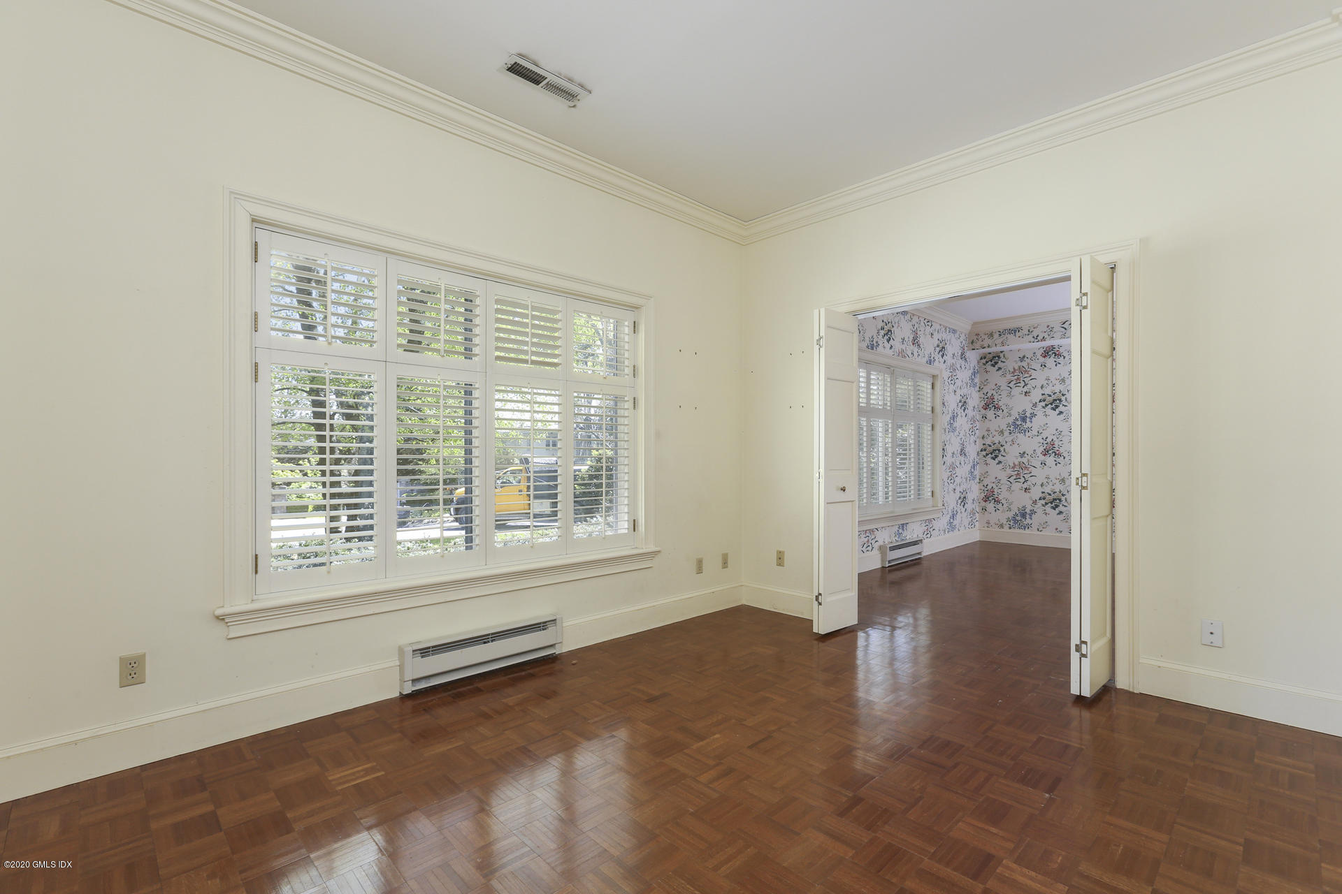 680 Steamboat Road, Unit 6 Greenwich, CT 06830 - Photo 15 of 40 a view of an empty room with a window and wooden floor