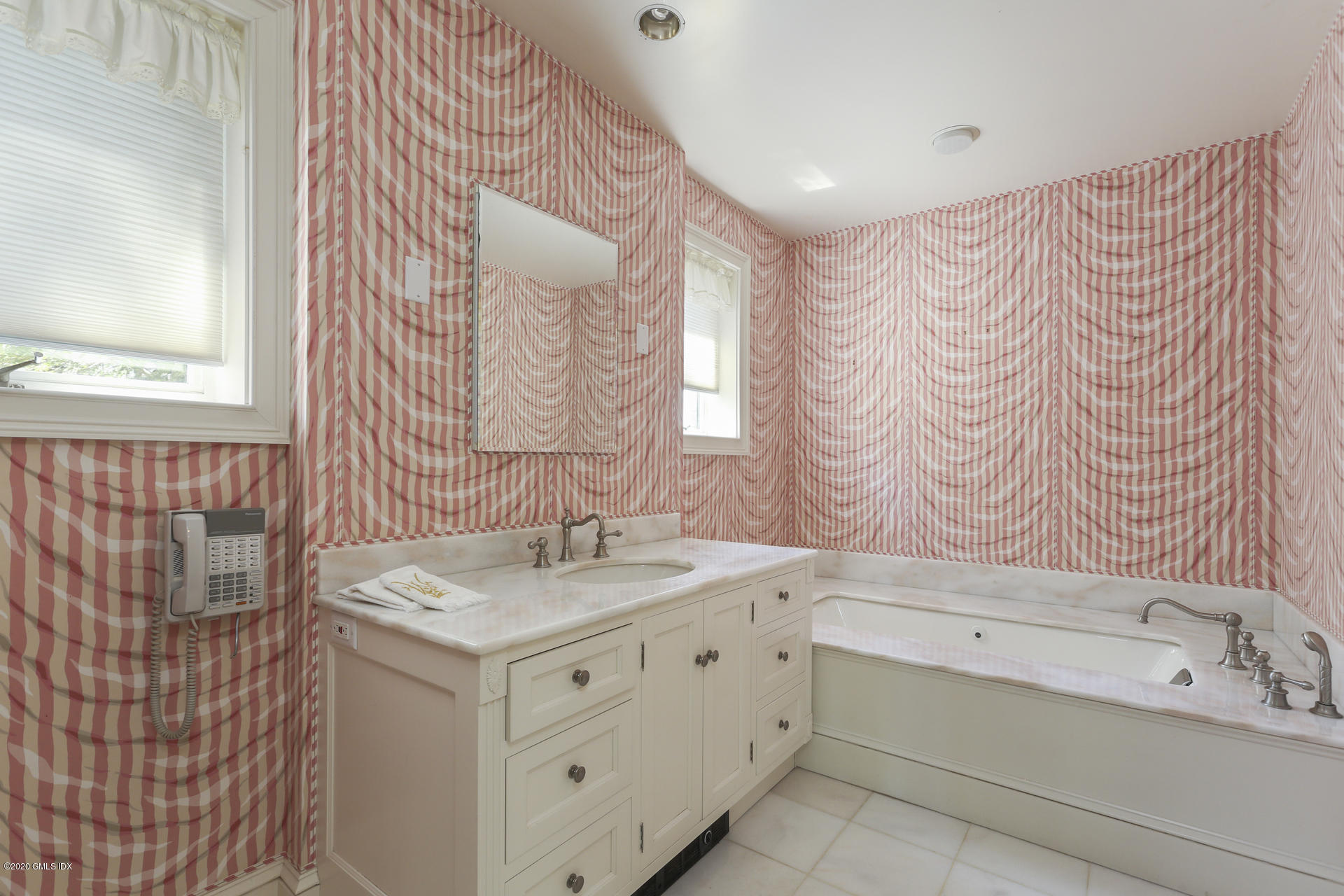 680 Steamboat Road, Unit 6 Greenwich, CT 06830 - Photo 17 of 40 a bathroom with a sink and a mirror