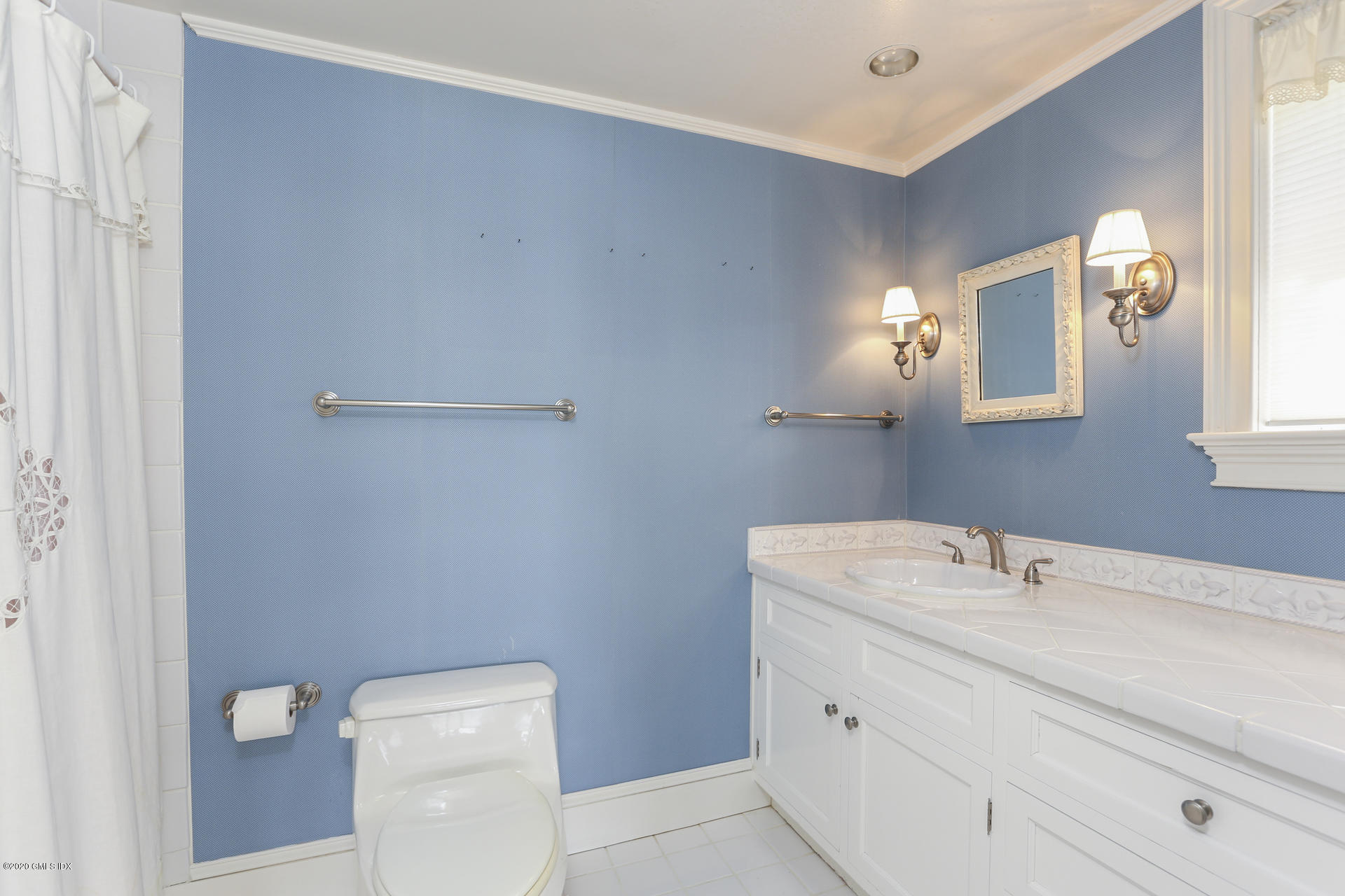 680 Steamboat Road, Unit 6 Greenwich, CT 06830 - Photo 28 of 40 a bathroom with a toilet sink and mirror