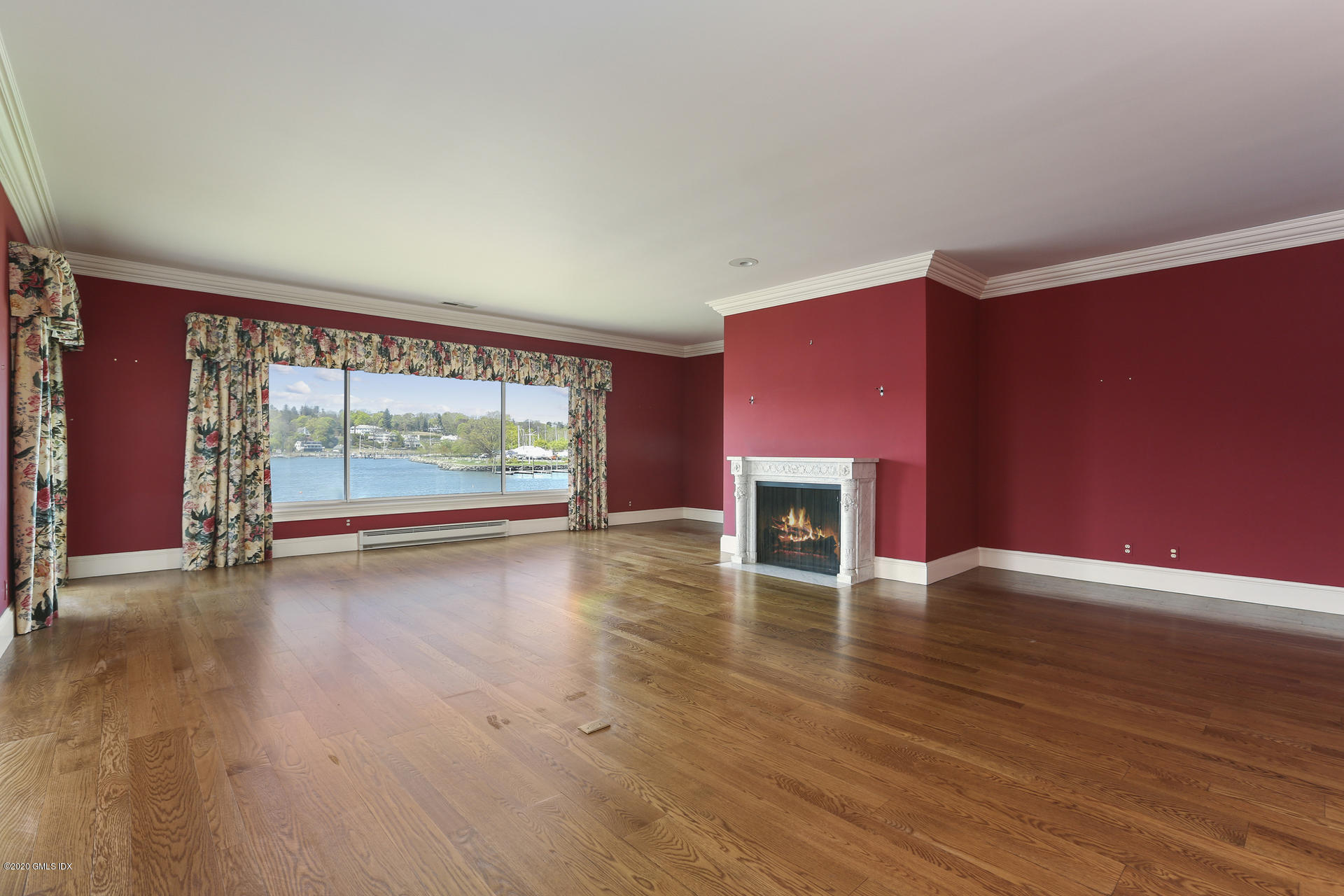 680 Steamboat Road, Unit 6 Greenwich, CT 06830 - Photo 6 of 40 an empty room with wooden floor and windows