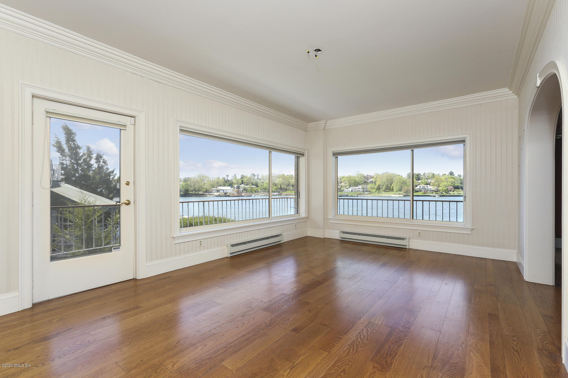 680 Steamboat Road, Unit 6 Greenwich, CT 06830 - Photo 8 of 40 a view of an empty room with wooden floor and a window
