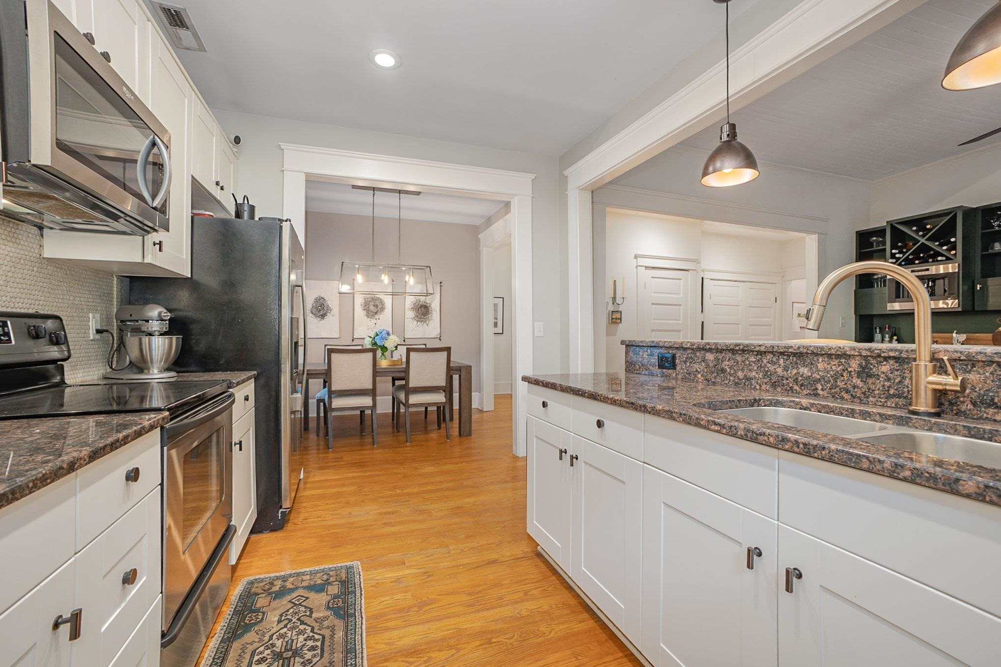 908 Burch Avenue Durham, NC 27701 - Photo 11 of 27 a large kitchen with stainless steel appliances granite countertop a sink and cabinets