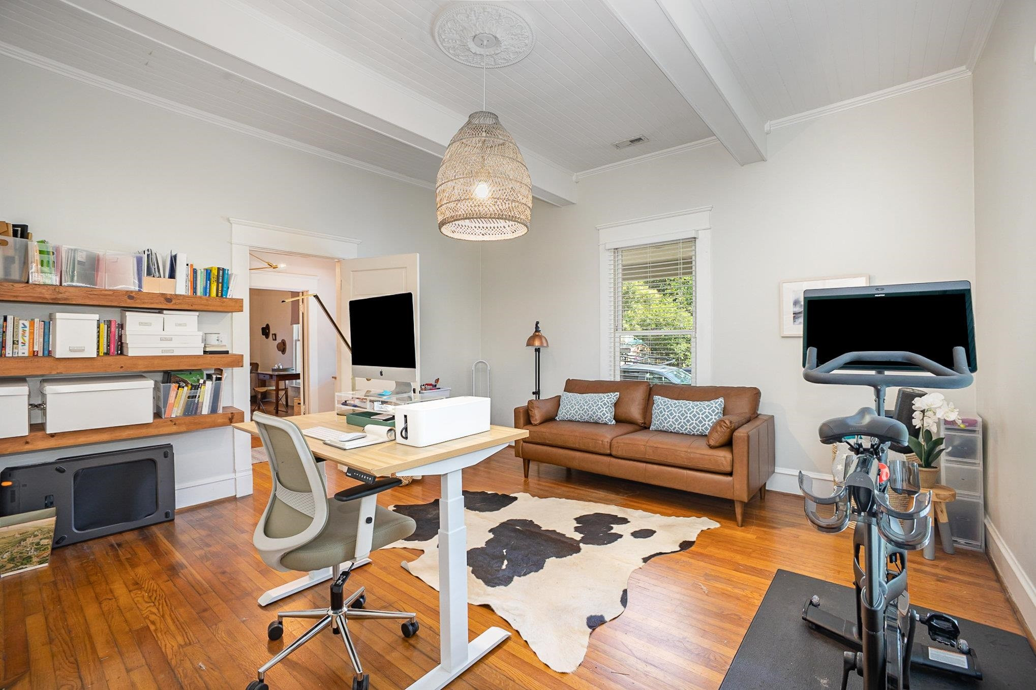 908 Burch Avenue Durham, NC 27701 - Photo 16 of 27 a living room with furniture a flat screen tv and a bookshelf
