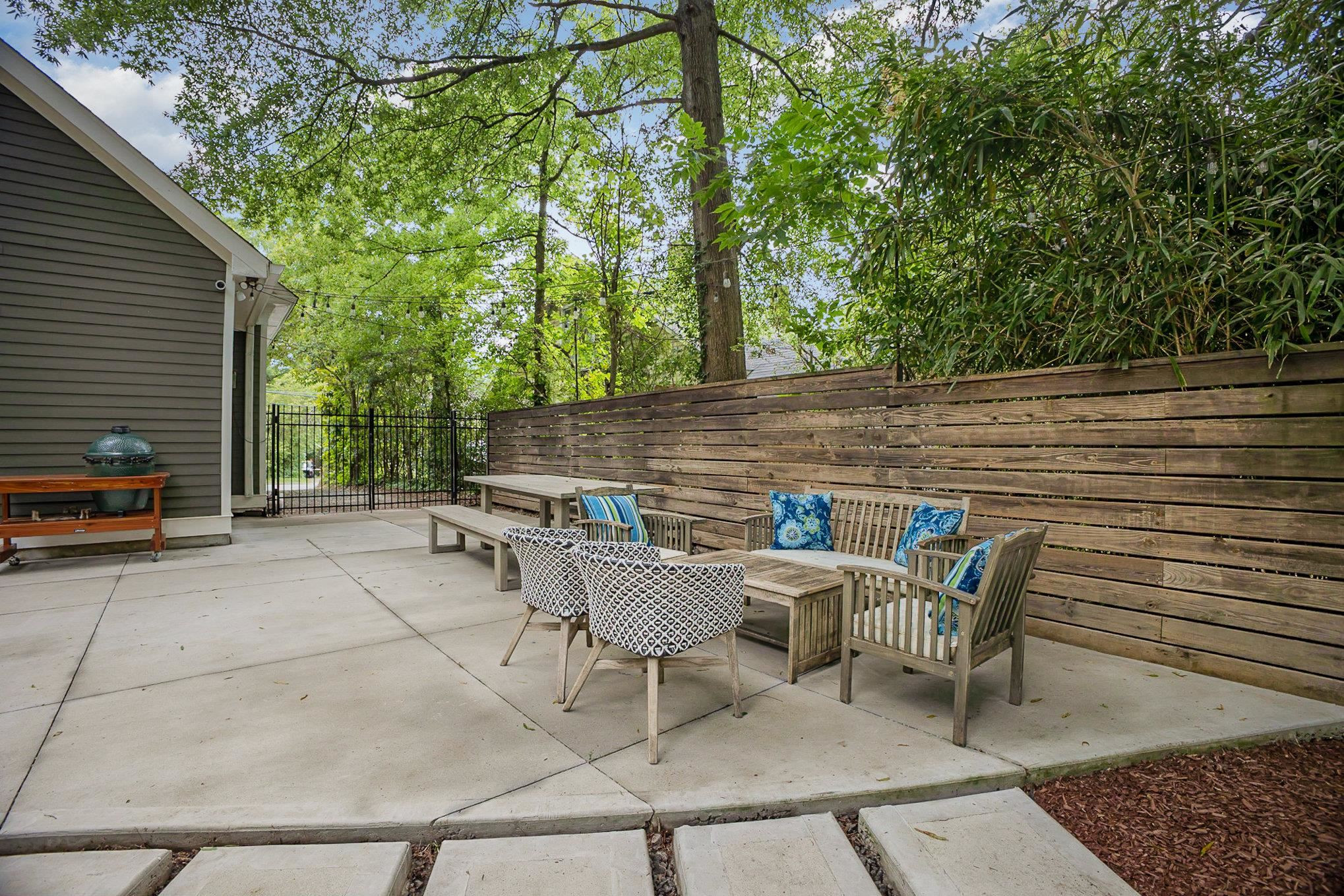 908 Burch Avenue Durham, NC 27701 - Photo 22 of 27 a view of patio with table and chairs with wooden fence and plants
