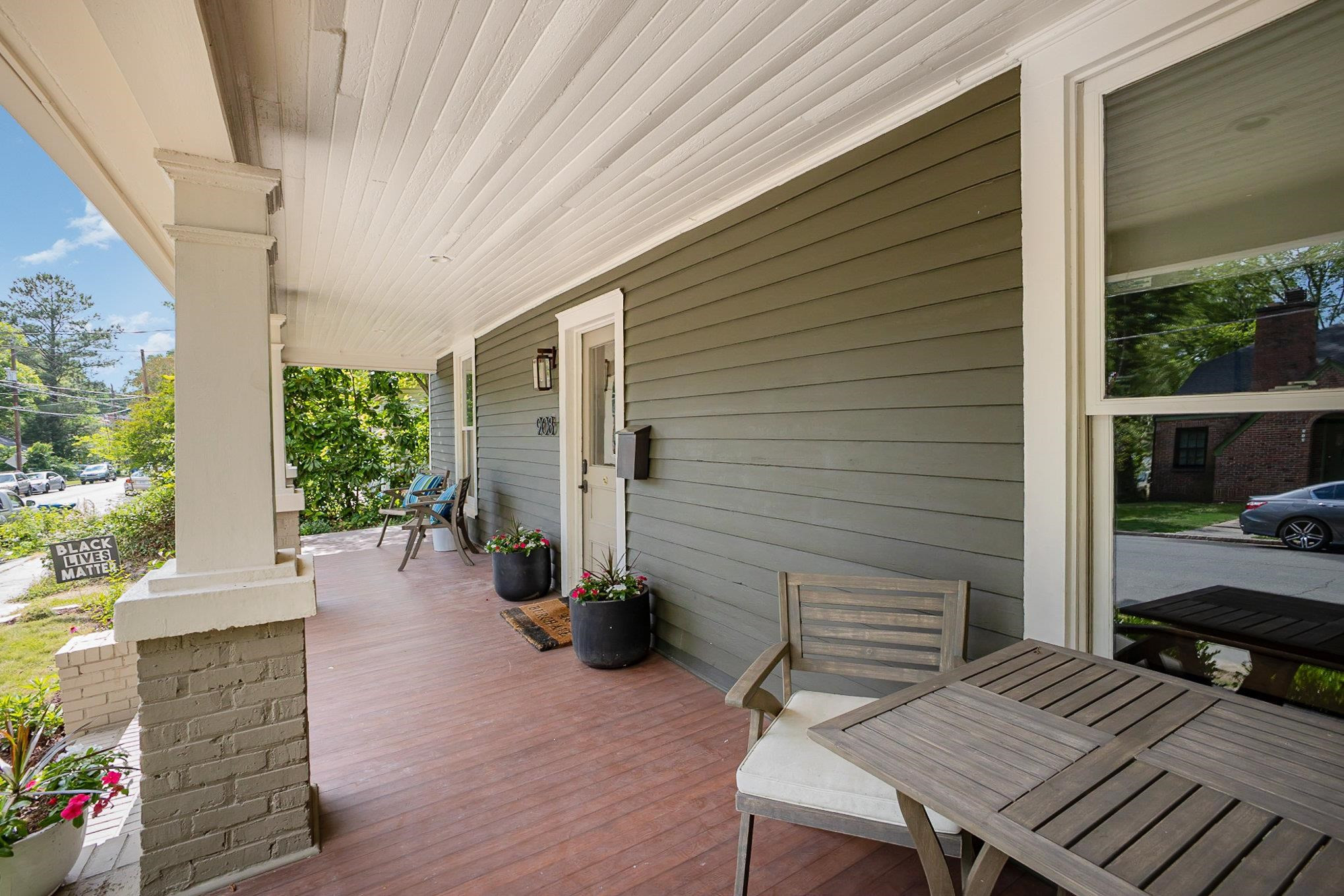 908 Burch Avenue Durham, NC 27701 - Photo 3 of 27 a view of a patio with table and chairs and wooden floor