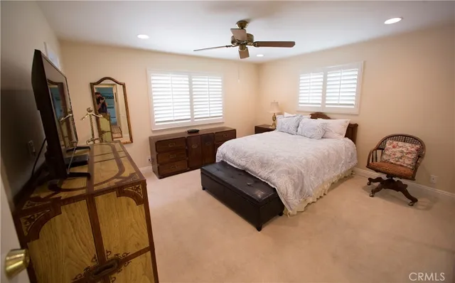 a bedroom with a bed couch and a window