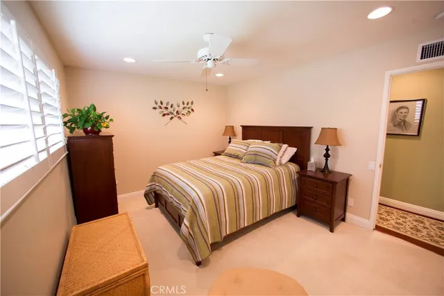 a bedroom with a bed and a potted plant