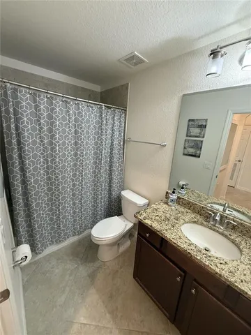 an aerial view of a house with a garden and lake view