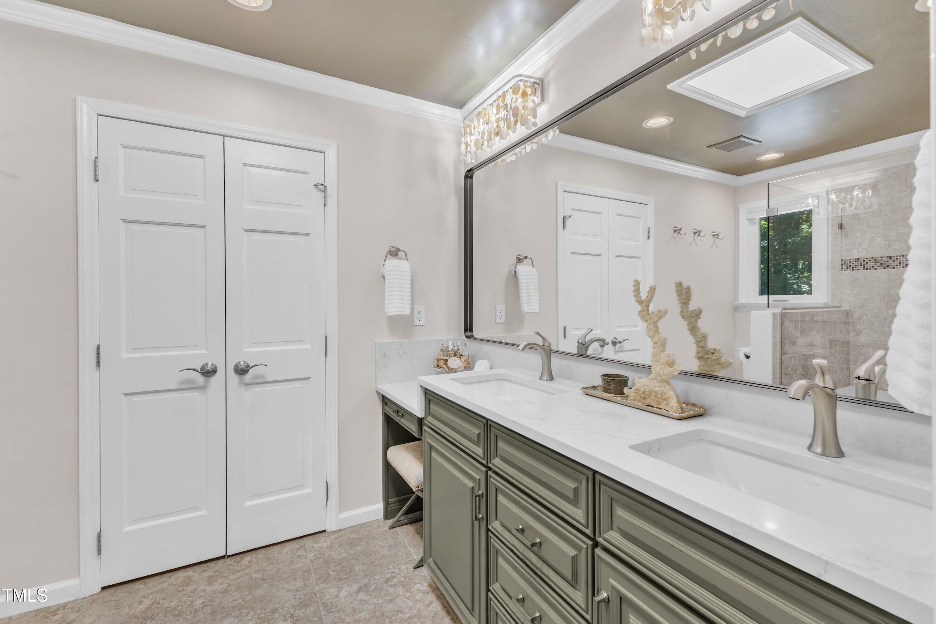 11100 Honeycutt Road Raleigh, NC 27614 - Photo 16 of 37 a bathroom with double vanity sink and a mirror