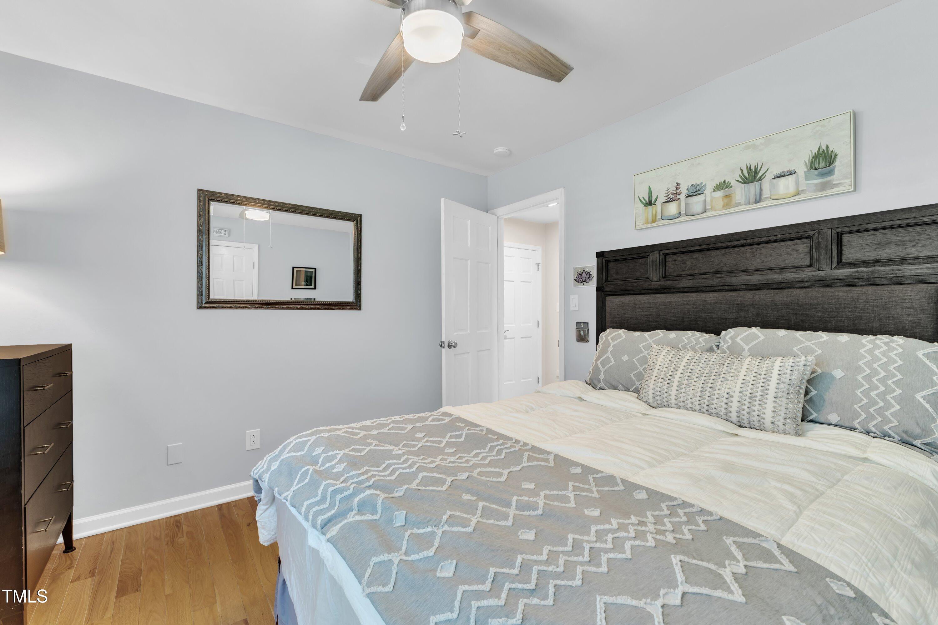 11100 Honeycutt Road Raleigh, NC 27614 - Photo 19 of 37 a bedroom with a bed and a painting on the wall