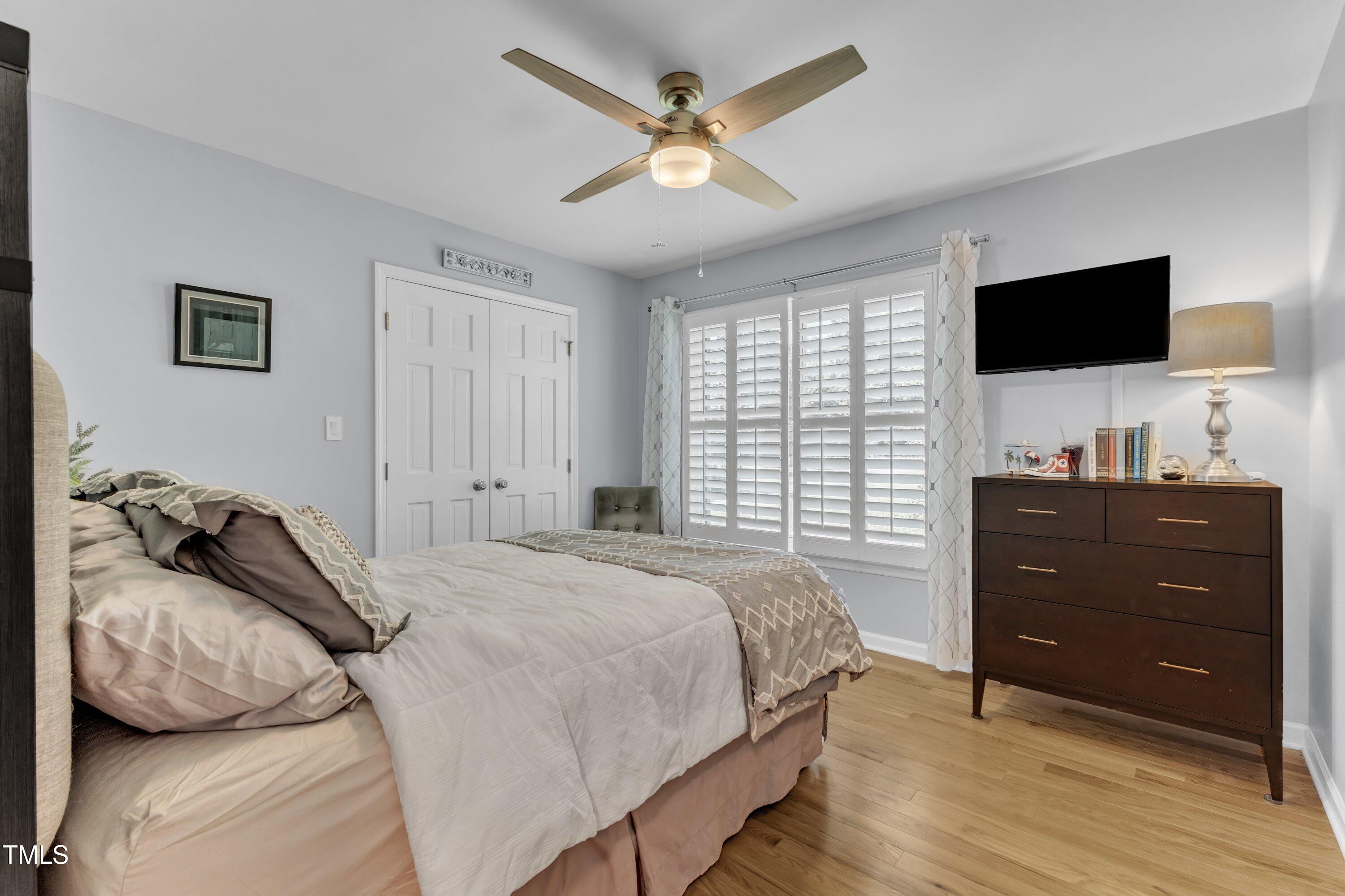 11100 Honeycutt Road Raleigh, NC 27614 - Photo 20 of 37 a bedroom with a bed and a flat screen tv