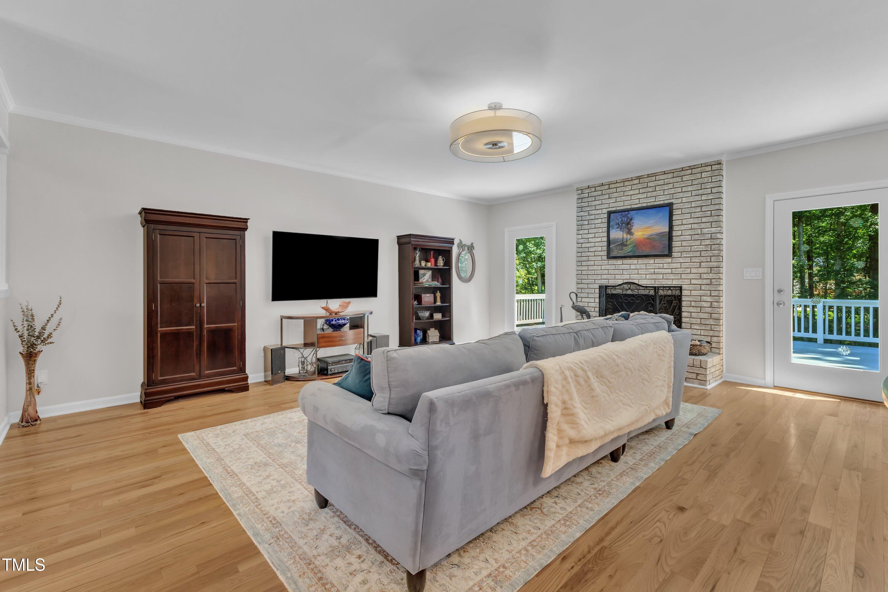 11100 Honeycutt Road Raleigh, NC 27614 - Photo 27 of 37 a living room with furniture and a flat screen tv