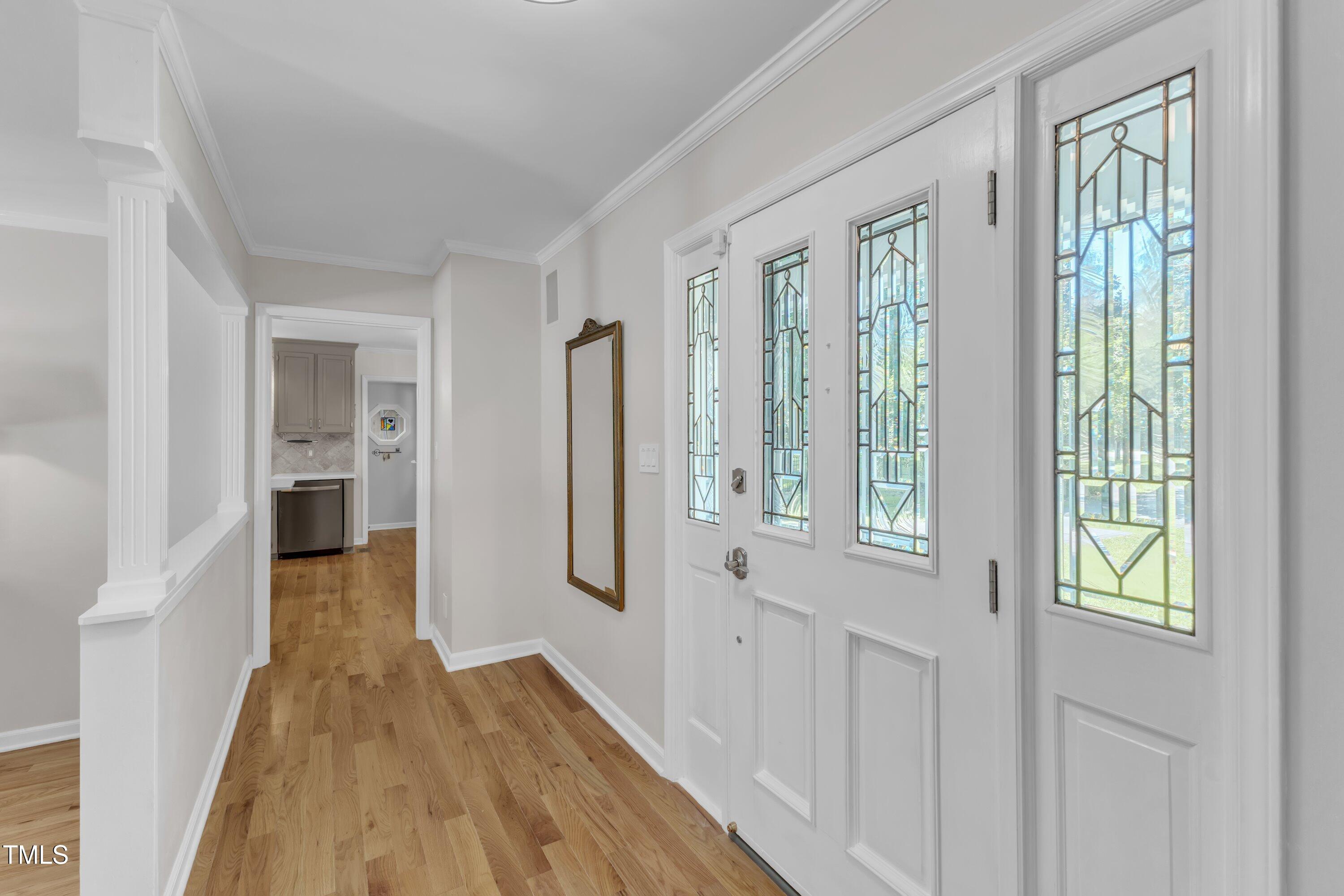 11100 Honeycutt Road Raleigh, NC 27614 - Photo 4 of 37 a view of hallway with wooden floor and stairs