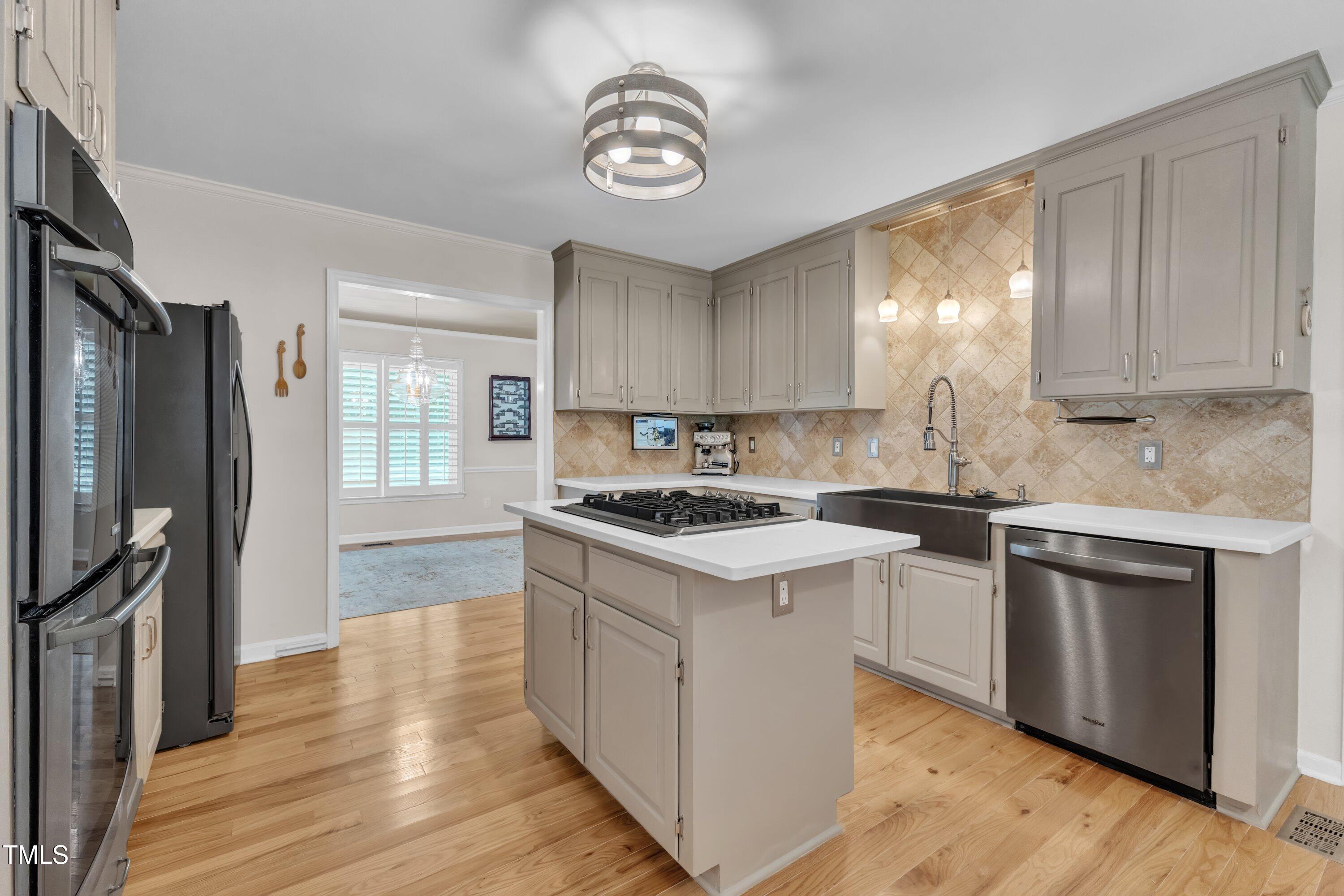 11100 Honeycutt Road Raleigh, NC 27614 - Photo 5 of 37 a kitchen with a stove a sink and a refrigerator