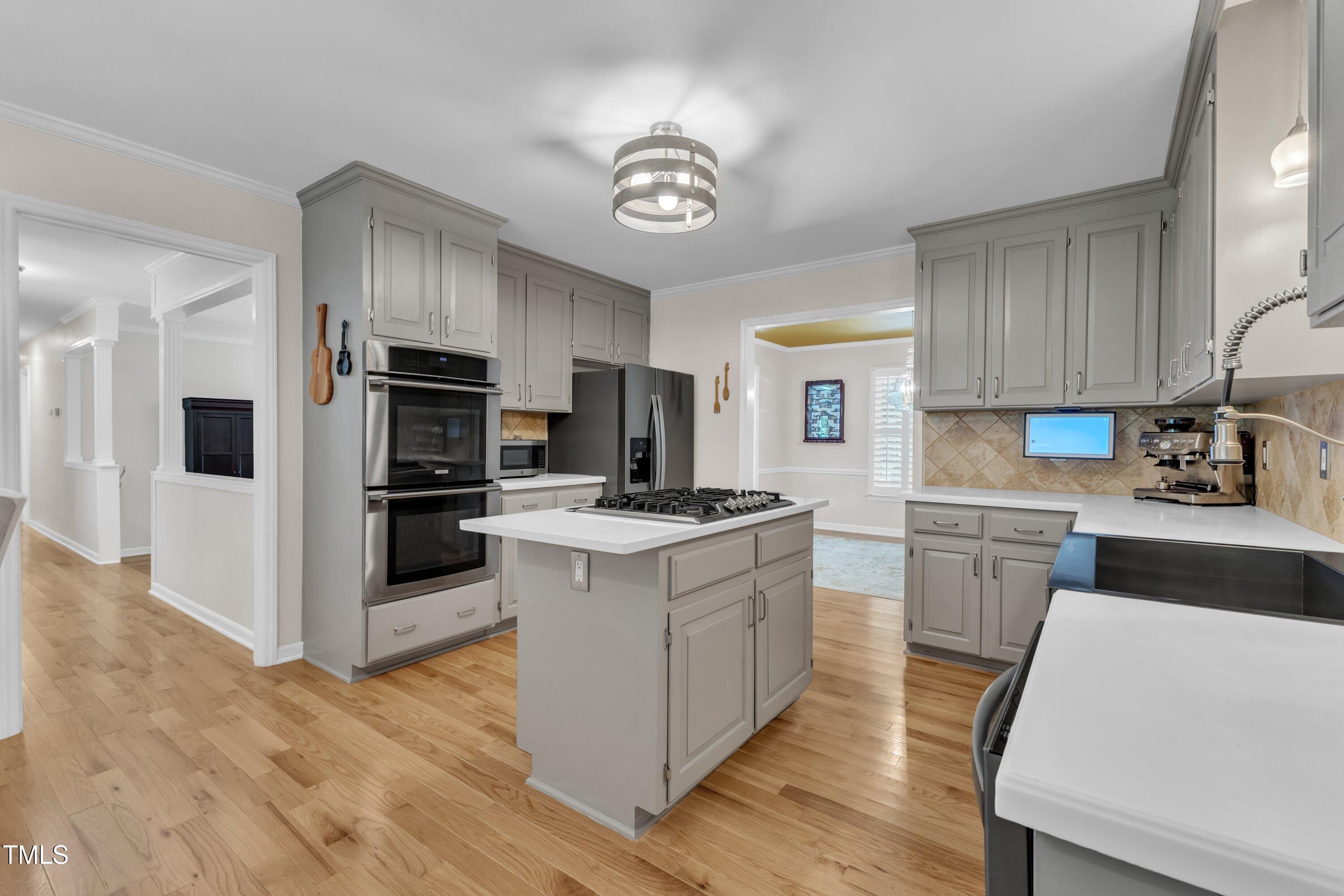 11100 Honeycutt Road Raleigh, NC 27614 - Photo 6 of 37 a kitchen with kitchen island granite countertop a stove oven and a refrigerator