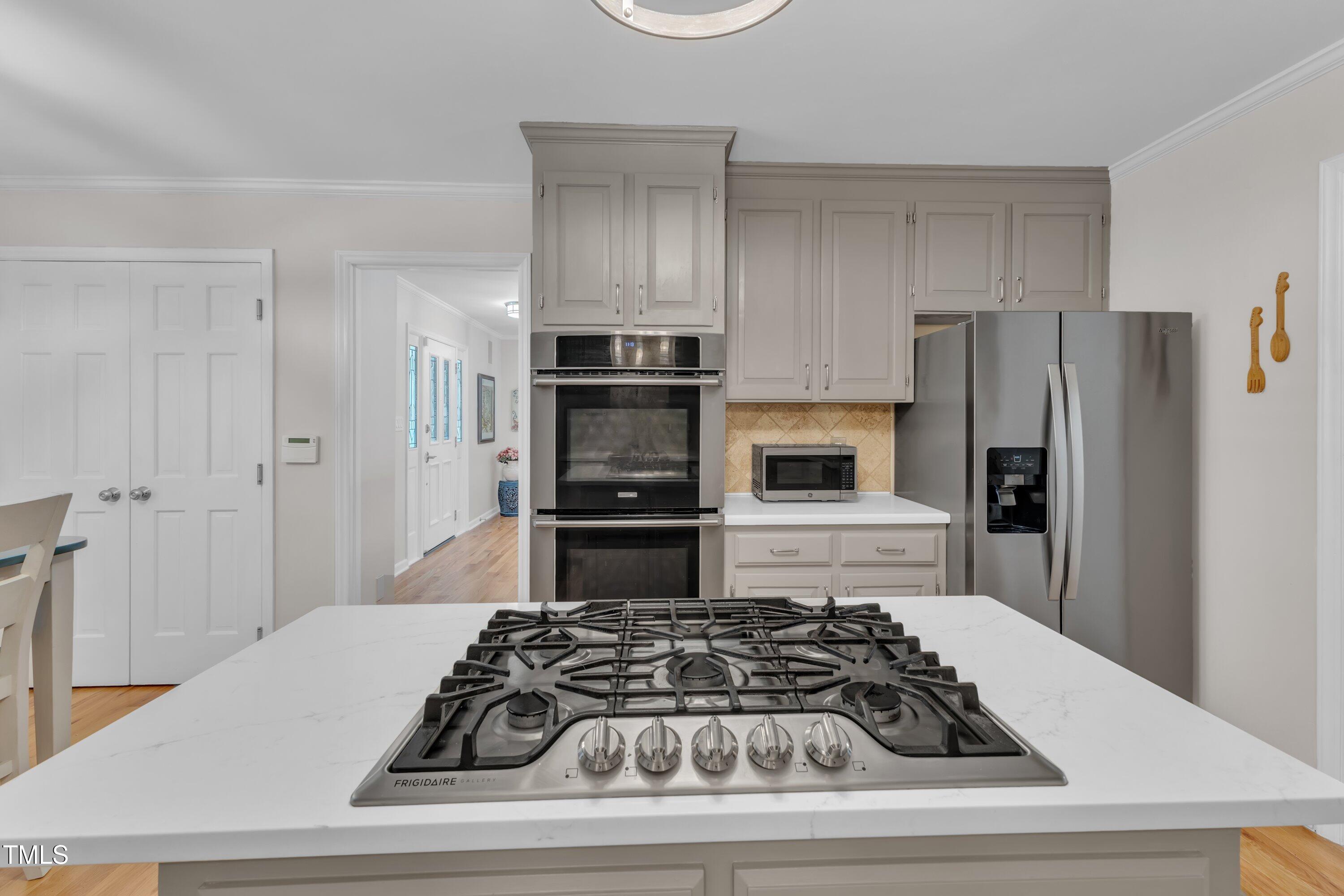 11100 Honeycutt Road Raleigh, NC 27614 - Photo 8 of 37 a kitchen with a refrigerator and a stove
