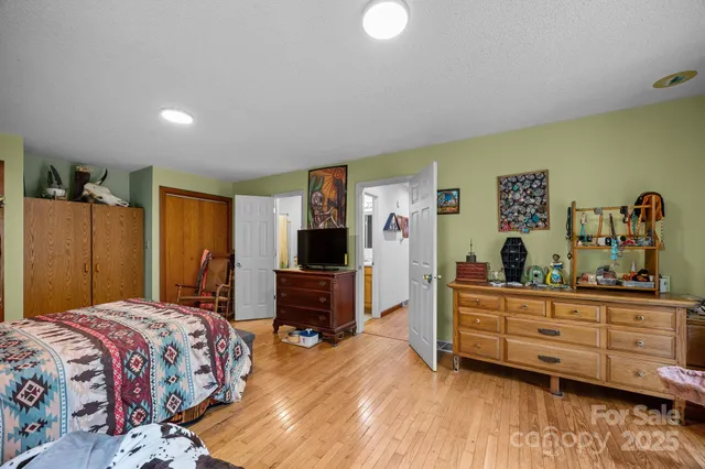 a bedroom with a bed and a dresser in it