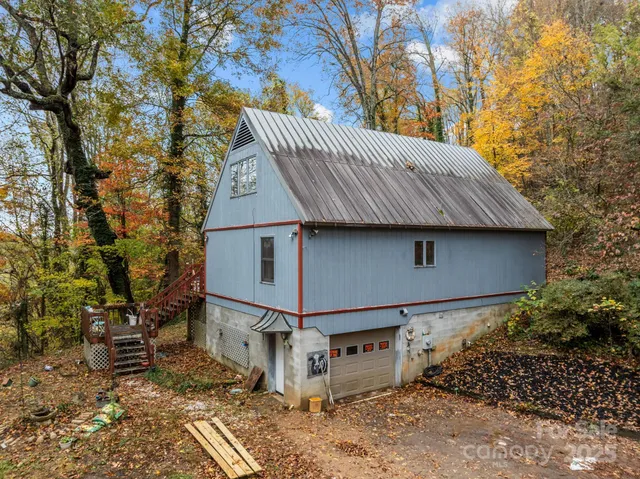 a backyard of a house with table and chairs