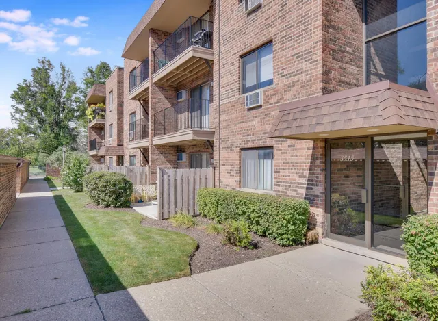 a view of a brick house with a yard