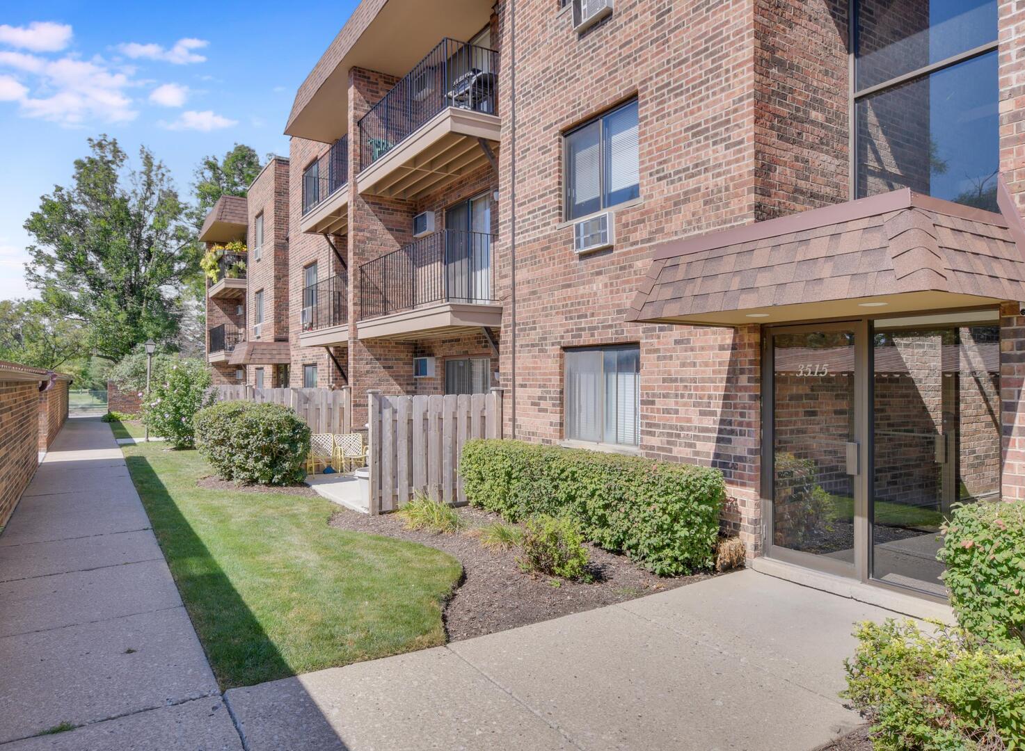 a view of a brick house with a yard