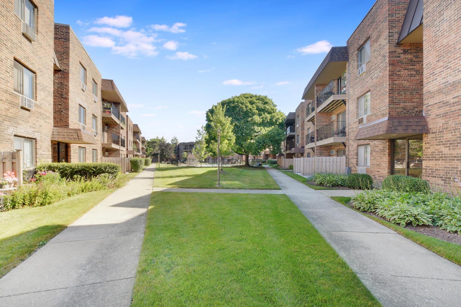 3531 East Central Road, Unit 101 Des Plaines, IL 60025 - Photo 14 of 15 a view of a building with a yard