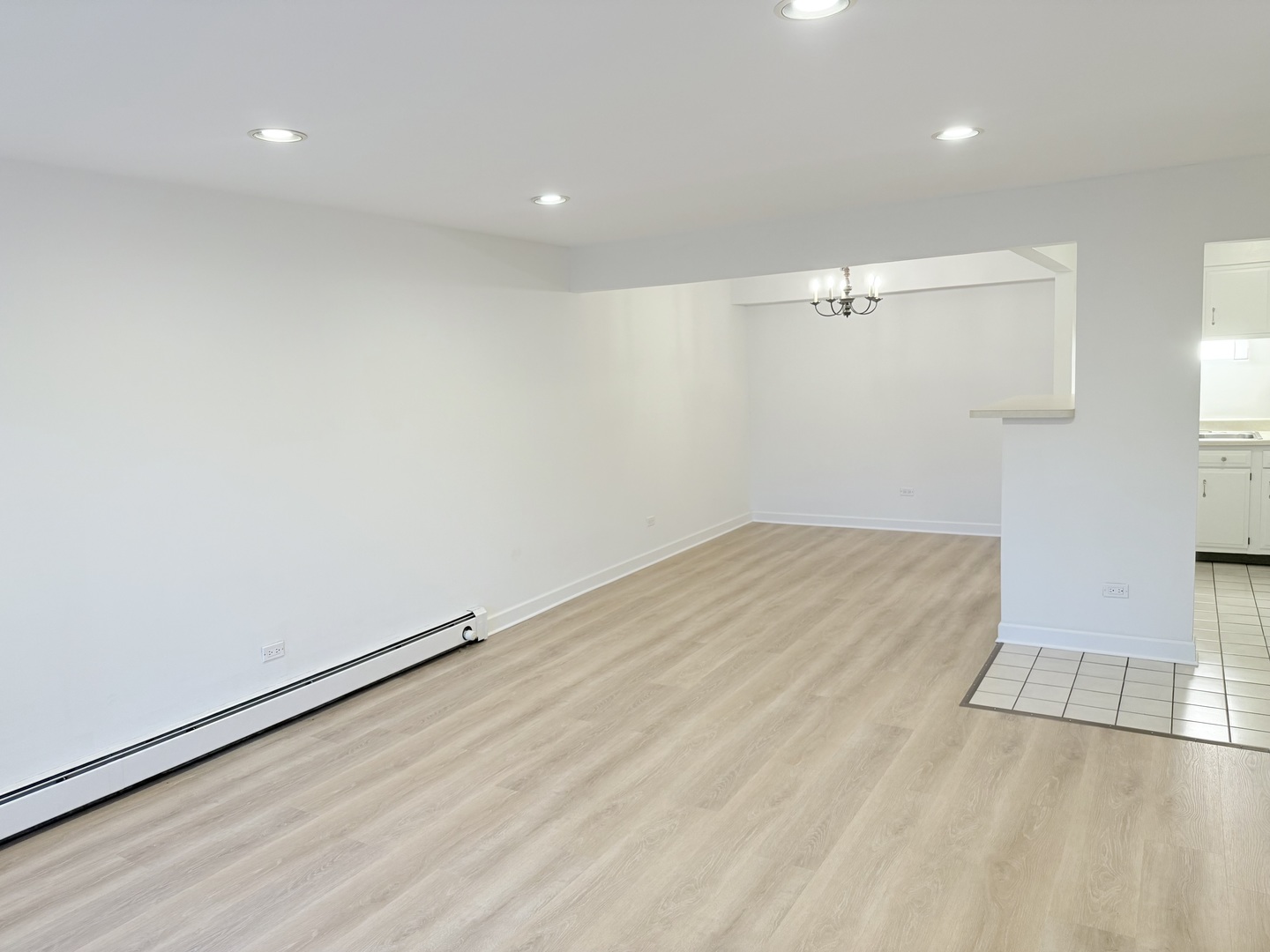 3531 East Central Road, Unit 101 Des Plaines, IL 60025 - Photo 5 of 15 an empty room with wooden floor and windows