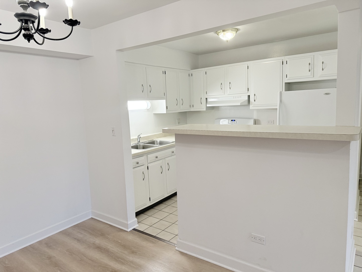 3531 East Central Road, Unit 101 Des Plaines, IL 60025 - Photo 9 of 15 a kitchen with white cabinets and white appliances