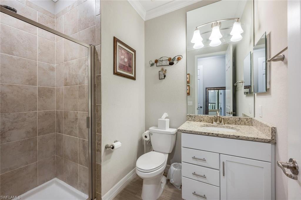 2115 Antigua Lane Naples, FL 34120 - Photo 30 of 41 #3 Full bath featuring a shower stall, crown molding, and vanity