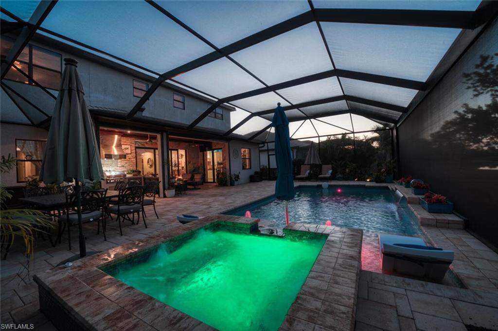 2115 Antigua Lane Naples, FL 34120 - Photo 33 of 41 View of swimming pool with a sunroom, a lanai, a patio, and a pool with connected hot tub