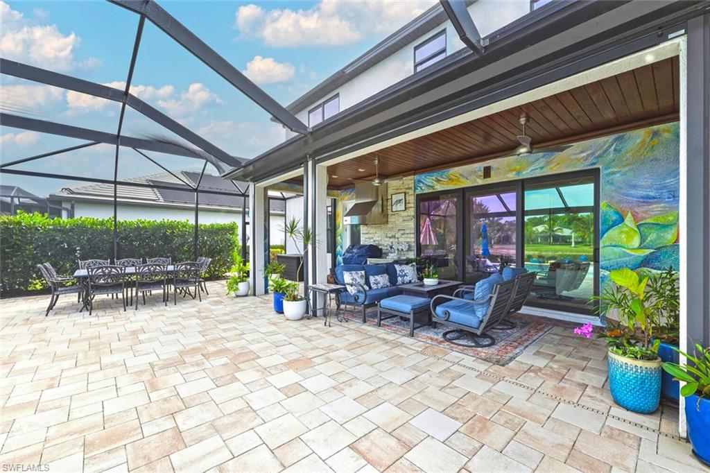 2115 Antigua Lane Naples, FL 34120 - Photo 34 of 41 View of patio featuring a ceiling fan, a lanai, a sunroom, outdoor lounge area, and outdoor dining area
