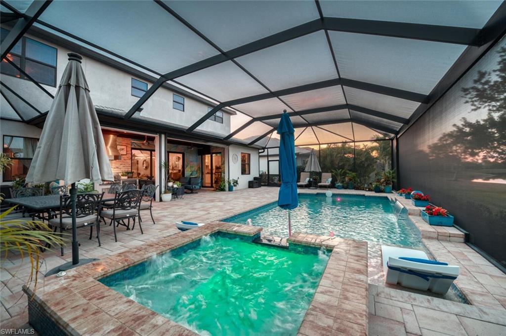 2115 Antigua Lane Naples, FL 34120 - Photo 36 of 41 View of pool with a sunroom, a patio area, a lanai, and a pool with connected hot tub