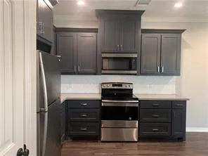 a kitchen with appliances and cabinets
