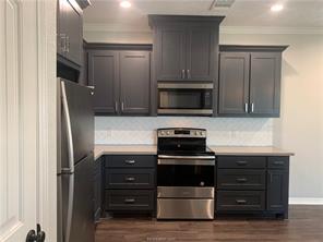6939 Halter Loop College Station, TX 77845 - Photo 5 of 12 a kitchen with appliances and cabinets