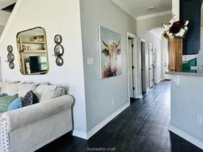a living room with furniture and a mirror