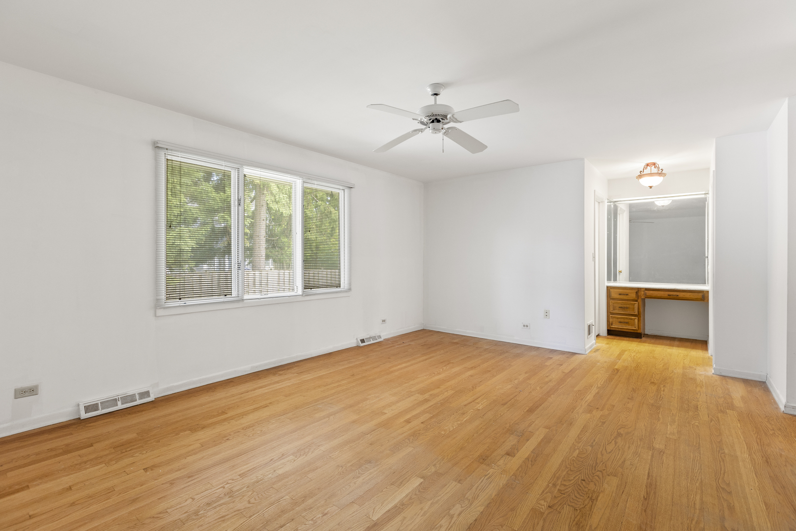 1046 Illinois Road Wilmette, IL 60091 - Photo 18 of 24 a view of a livingroom with a ceiling fan and window