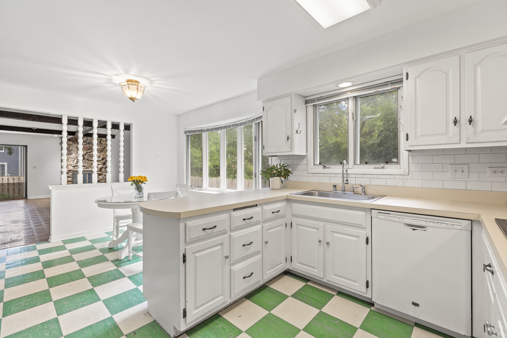 1046 Illinois Road Wilmette, IL 60091 - Photo 8 of 24 a kitchen with a sink stove and cabinets