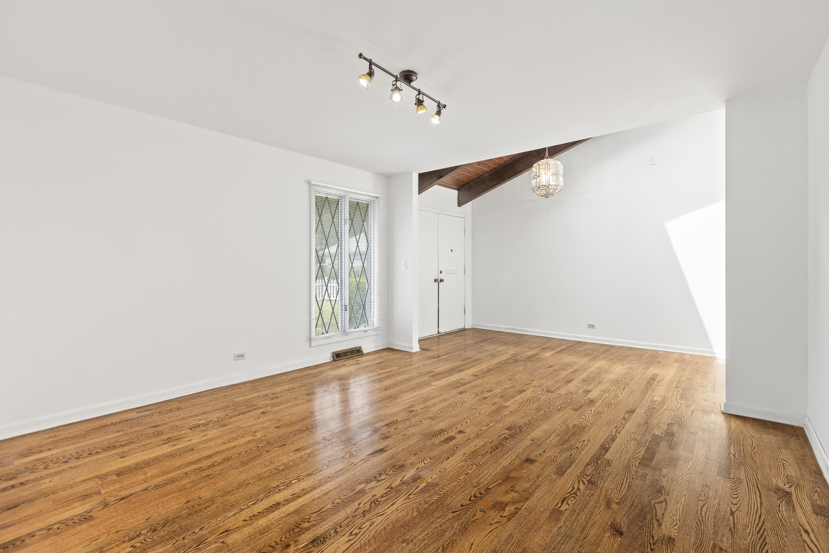 1046 Illinois Road Wilmette, IL 60091 - Photo 10 of 24 a view of an empty room with wooden floor