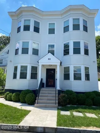 a front view of a brick house with a yard