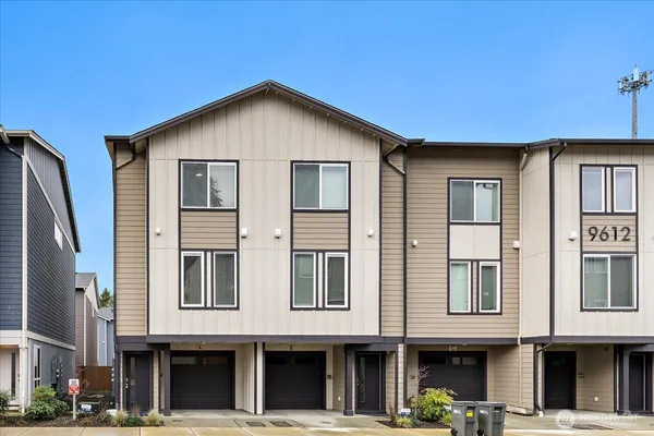 a front view of a residential apartment building with a yard