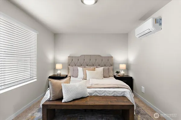 a bedroom with a bed and a lamp
