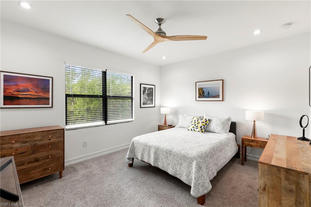 7515 Morgan Way Naples, FL 34119 - Photo 12 of 34 a bedroom with a bed a dresser next to a window