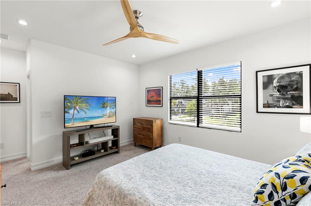 7515 Morgan Way Naples, FL 34119 - Photo 13 of 34 a bedroom with furniture and a flat screen tv