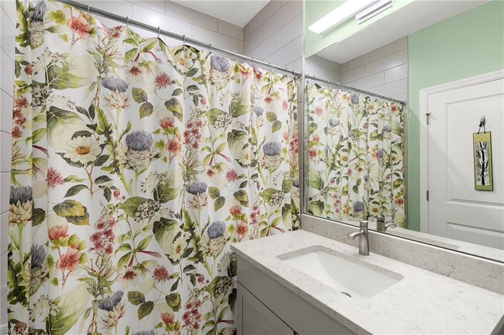 7515 Morgan Way Naples, FL 34119 - Photo 17 of 34 a bathroom with a sink and a mirror