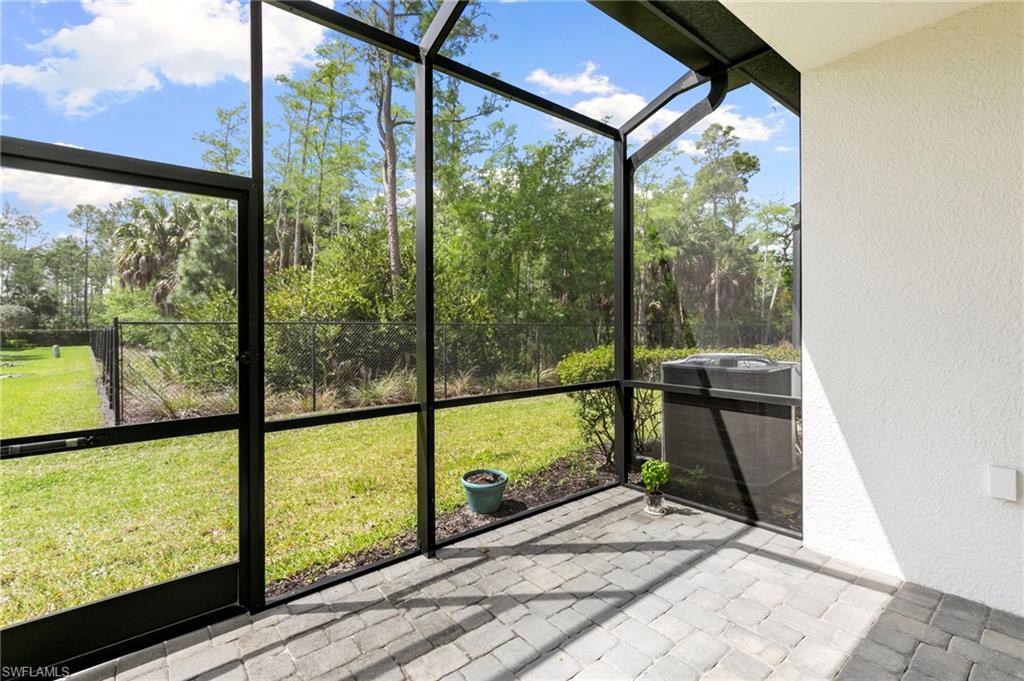 7515 Morgan Way Naples, FL 34119 - Photo 22 of 34 a view of a room with wooden floor and windows