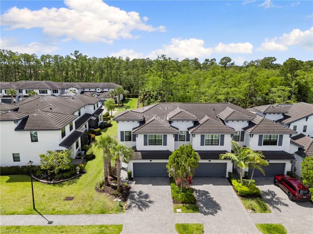 7515 Morgan Way Naples, FL 34119 - Photo 25 of 34 an aerial view of multiple houses with a yard