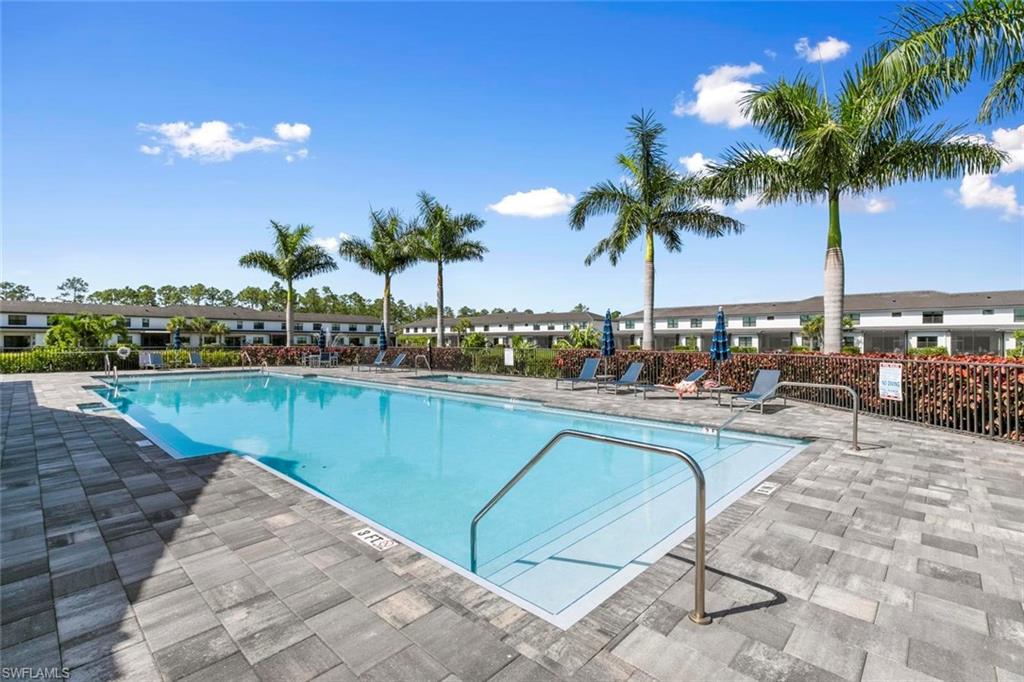 7515 Morgan Way Naples, FL 34119 - Photo 30 of 34 a view of a swimming pool and lounge chairs