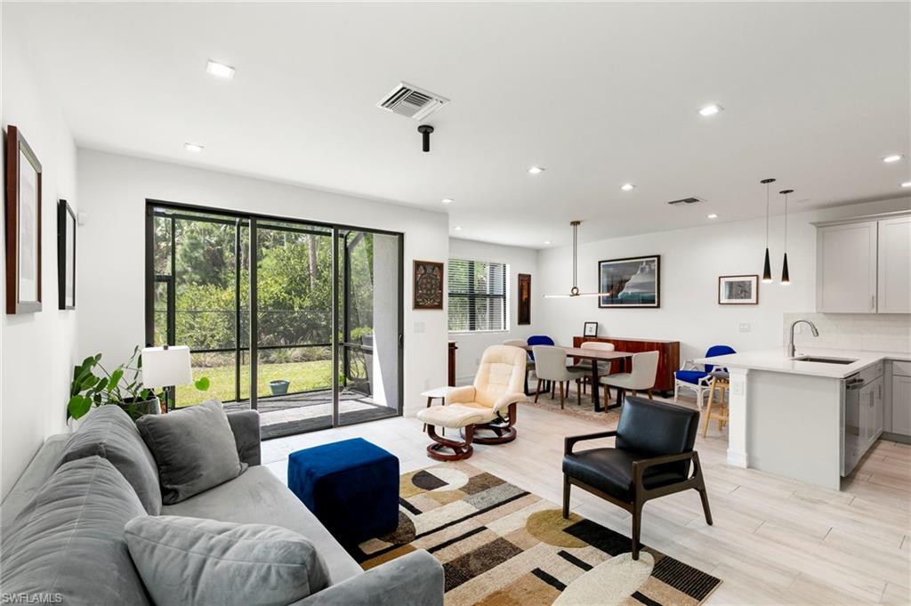 7515 Morgan Way Naples, FL 34119 - Photo 3 of 34 a living room with furniture and a large window